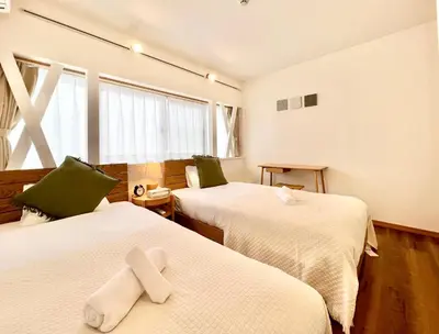 a room with two beds with crosses on them at MX Hotel Roppongi in Tokyo