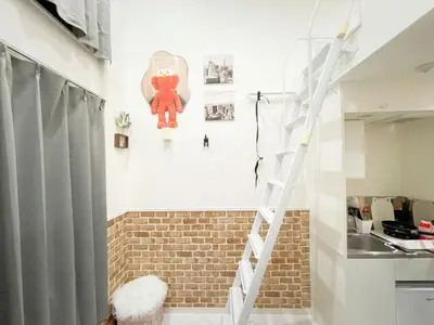 a staircase in a room with a brick wall at \u5c71\u624b\u7dda\u65b0\u5927\u4e45\u4fdd\u99c508 in Tokyo