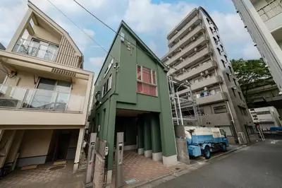 a green building next to two tall buildings at 65, Simotakaido A, Entire house for rent, \u4e0b\u9ad8\u4e95\u6238A in Tokyo