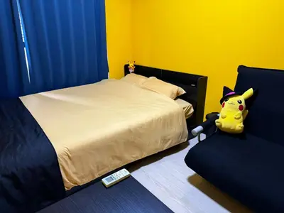 a bedroom with a bed with a stuffed animal on the floor at TRAVELERZ Tokyo Akasaka in Tokyo
