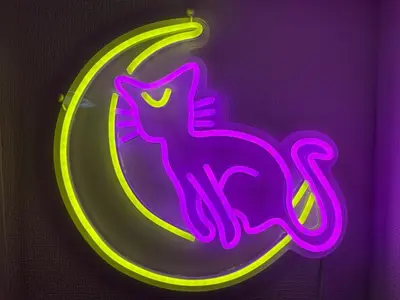 a neon sign with a cat sitting on the moon at TRAVELERZ Tokyo Akasaka in Tokyo
