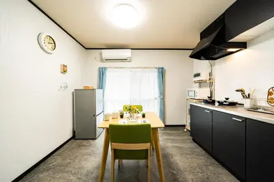 a kitchen with a table and a refrigerator at 39, Kanegafuchi 2, Entire house for rent, \u9418\u30f6\u6df52 in Tokyo