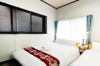 two beds in a room with two windows at 39, Kanegafuchi 2, Entire house for rent, \u9418\u30f6\u6df52 in Tokyo
