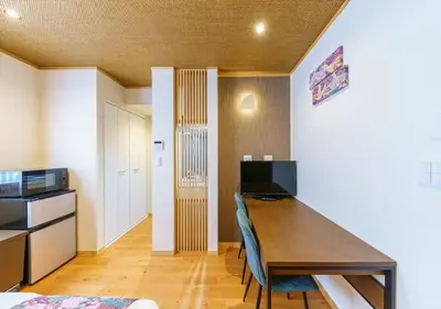 a room with a wooden table and a kitchen at Yadoya Suzume - Vacation STAY 60192v in Tokyo