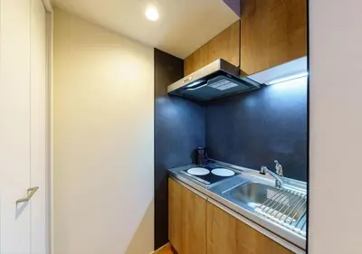 a kitchen with a sink and a black wall at Yadoya Suzume - Vacation STAY 60192v in Tokyo