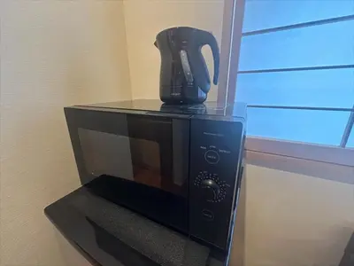 a black coffee pot sitting on top of a microwave at Yadoya Suzume - Vacation STAY 60192v in Tokyo