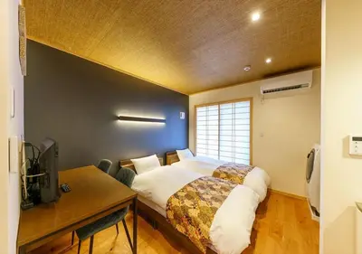 a bedroom with a bed and a desk and a window at Yadoya Suzume - Vacation STAY 60198v in Tokyo