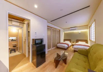 a hotel room with a couch and a bed at Ydoya Fukuro - Vacation STAY 52727v in Tokyo