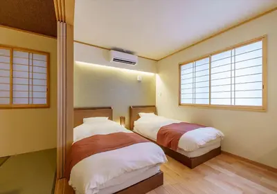 two beds in a room with two windows at Ydoya Fukuro - Vacation STAY 52727v in Tokyo