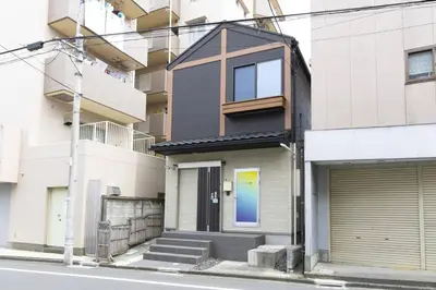 a house on a street with a building at SLEEPLAB \u6d45\u8349 -Asakusa- in Tokyo