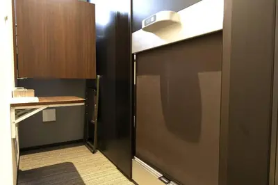 a small kitchen with a refrigerator and a counter at SLEEPLAB \u6d45\u8349 -Asakusa- in Tokyo