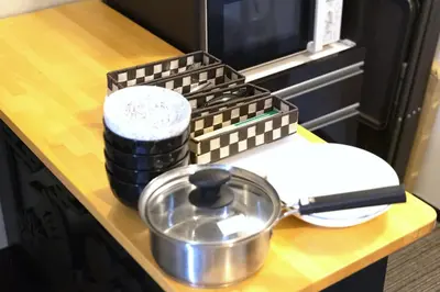 a kitchen counter with a pot and a box on it at SLEEPLAB \u6d45\u8349 -Asakusa- in Tokyo