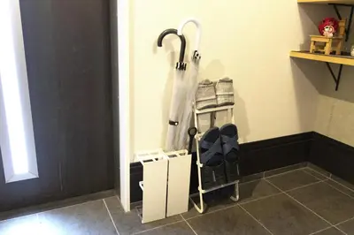 a room with a closet with umbrellas on the wall at SLEEPLAB \u6d45\u8349 -Asakusa- in Tokyo