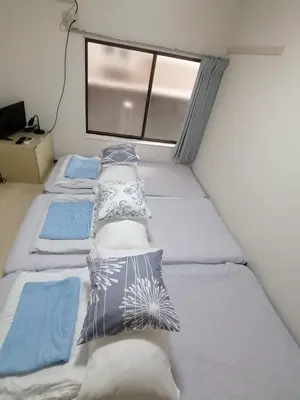 a bedroom with two beds and a window at Tokyo downtown in Tokyo