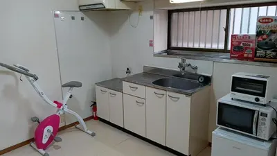 a small kitchen with a sink and a scooter at Tokyo downtown in Tokyo