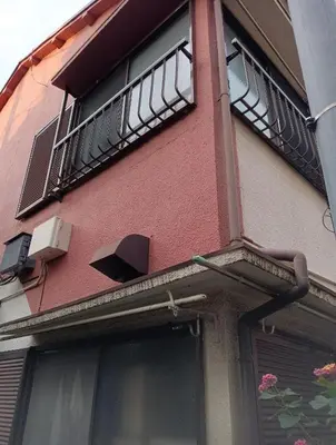a red building with a balcony and a window at Tokyo downtown in Tokyo