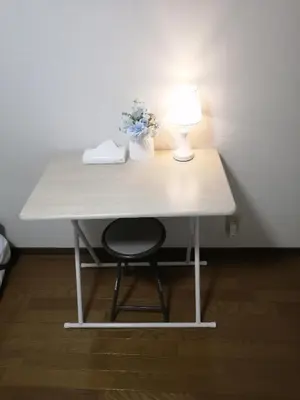 a white table with a lamp and flowers on it at Tokyo downtown in Tokyo