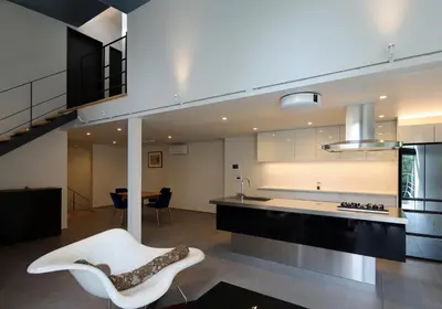 a kitchen with a white chair and a table at Spacious Home in Ebisu Heart of Tokyo in Tokyo