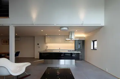 a kitchen with a table and a white chair at Spacious Home in Ebisu Heart of Tokyo in Tokyo