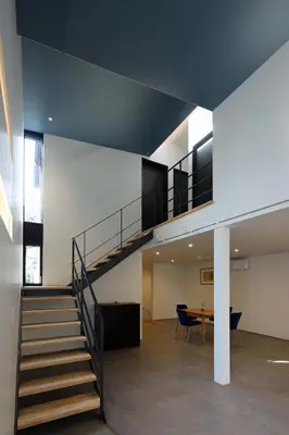 a staircase in a building with a table and chairs at Spacious Home in Ebisu Heart of Tokyo in Tokyo