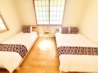 a small room with two beds and a window at \u6771\u4eac\u96f7\u9580\u30fc\u5343\u306e\u68eeAsakusa in Tokyo