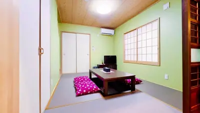 a room with a table in a room with green walls at \u6771\u4eac\u96f7\u9580\u30fc\u5343\u306e\u68eeAsakusa in Tokyo