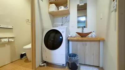 a washing machine in a bathroom with a sink at \u6771\u4eac\u96f7\u9580\u30fc\u5343\u306e\u68eeAsakusa in Tokyo