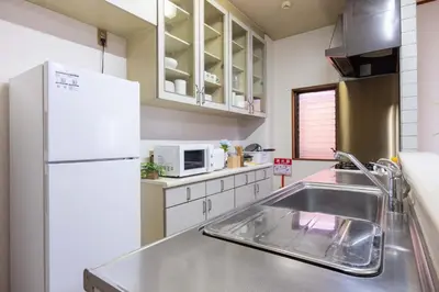 a kitchen with a sink and a white refrigerator at Higashi Komagata Building 2F3F HK23 in Tokyo
