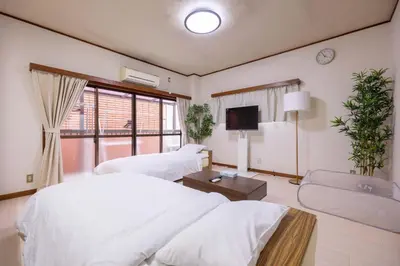 a hotel room with two beds and a tv at Higashi Komagata Building 2F3F HK23 in Tokyo