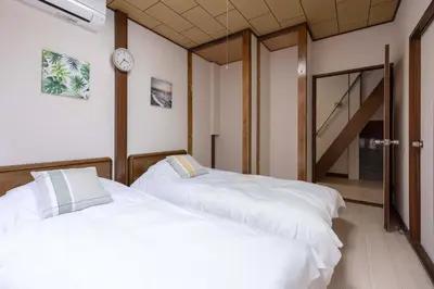 two white beds in a room with a staircase at Higashi Komagata Building 2F3F HK23 in Tokyo