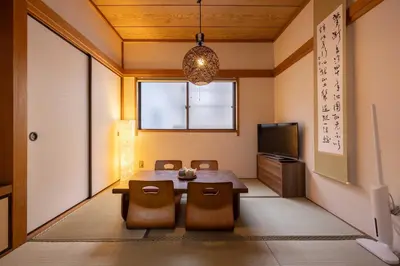 a dining room with a table and chairs and a tv at Higashi Komagata Building 2F3F HK23 in Tokyo