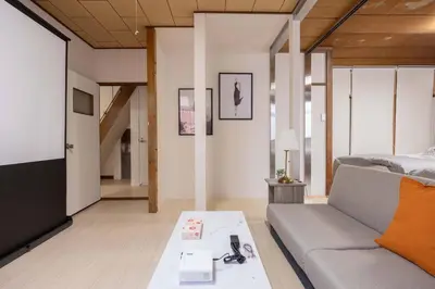 a living room with a couch and a tv at Higashi Komagata Building 2F3F HK23 in Tokyo