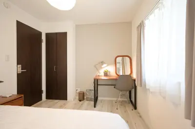 a bedroom with a desk and a mirror at Mi-Villa Kami-Ikebukuro in Tokyo
