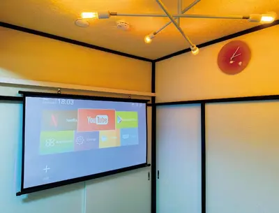 a projection screen in a room with a clock on the wall at 6min to subway, Skytree,Ueno,Asakusa within 20min in Tokyo