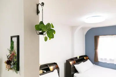 a room with two beds and a potted plant at 44, Sumiyoshi 2, Entire house for rent, \u4f4f\u54092 in Tokyo