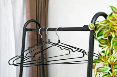a black metal towel rack next to a window at 44, Sumiyoshi 2, Entire house for rent, \u4f4f\u54092 in Tokyo
