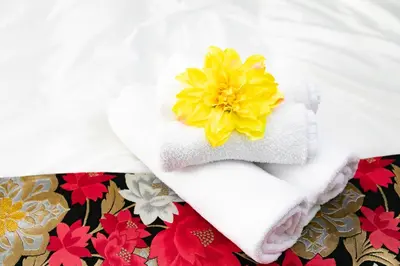 a white towel with a yellow flower on it at 44, Sumiyoshi 2, Entire house for rent, \u4f4f\u54092 in Tokyo
