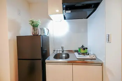 a small kitchen with a sink and a refrigerator at B22\u6c60\u888b\u4e2d\u5fc3 \u4e24\u5ba4 \u4ea4\u901a\u4fbf\u5229 \u8f66\u7ad93\u5206\u949f 2 rooms Ikebukuro center 3 mins to ST Max 5P \u76f4\u8fbe\u65b0\u5bbf \u6d89\u8c37 \u8868\u53c2\u9053 \u6c60\u888b \u4e0a\u91ce \u4ee3\u4ee3\u6728 \u94f6\u5ea7 \u539f\u5bbf in Tokyo