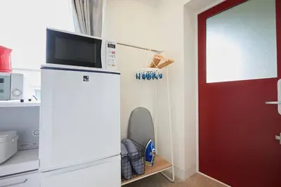 a microwave on top of a refrigerator in a kitchen at Shateray Yoyogi 501 SY51 in Tokyo