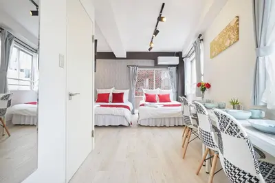 a room with two beds and a table and chairs at Shateray Yoyogi 501 SY51 in Tokyo