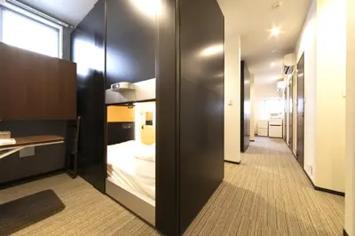 a hallway with a bed in a small room at SLEEPLAB Asakusa - Vacation STAY 13540v in Tokyo