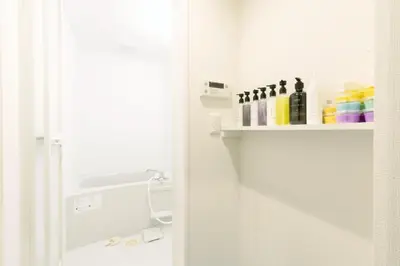 a bathroom with a shelf with cleaning products on it at SLEEPLAB Asakusa - Vacation STAY 13540v in Tokyo