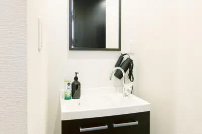 a bathroom with a white sink and a mirror at SLEEPLAB Asakusa - Vacation STAY 13540v in Tokyo