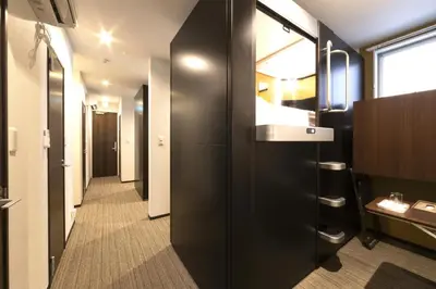 a bathroom with black walls and a long hallway at SLEEPLAB Asakusa - Vacation STAY 13540v in Tokyo