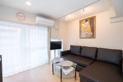 a living room with a couch and a table at One Bedroom Family Suite Close Ikebukuro Max 4ppl in Tokyo