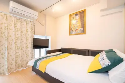 a bedroom with a bed and a picture on the wall at One Bedroom Family Suite Close Ikebukuro Max 4ppl in Tokyo