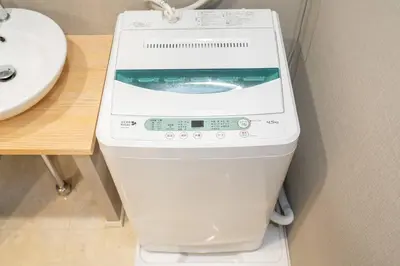 a washer and dryer sitting next to a sink at One Bedroom Family Suite Close Ikebukuro Max 4ppl in Tokyo