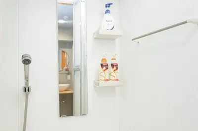 a bathroom with a shower and a door with a sink at One Bedroom Family Suite Close Ikebukuro Max 4ppl in Tokyo