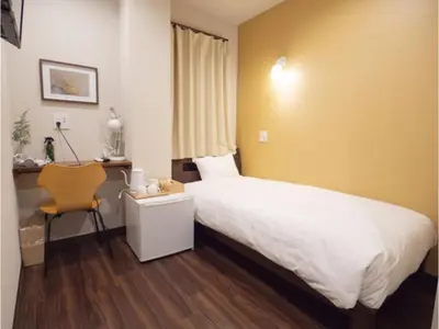 a hotel room with a bed and a chair at ELE HOTEL Higashi Ueno - Vacation STAY 07985v in Tokyo
