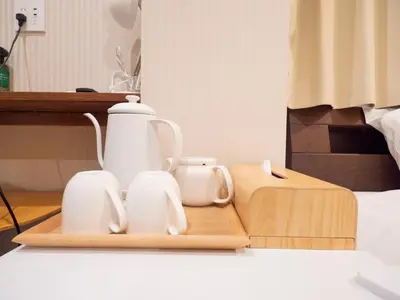 a tea kettle and two cups on a wooden tray at ELE HOTEL Higashi Ueno - Vacation STAY 07985v in Tokyo